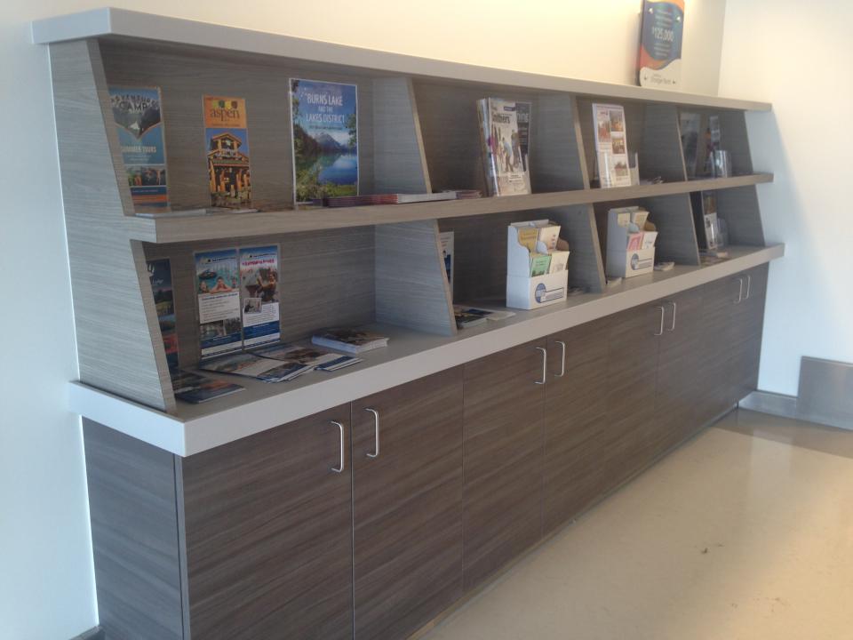 A grey shelf displaying brochures